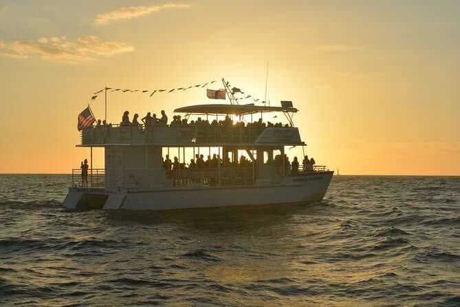 Sunset cruise boat on the Mandovi river, Goa, with golden sky